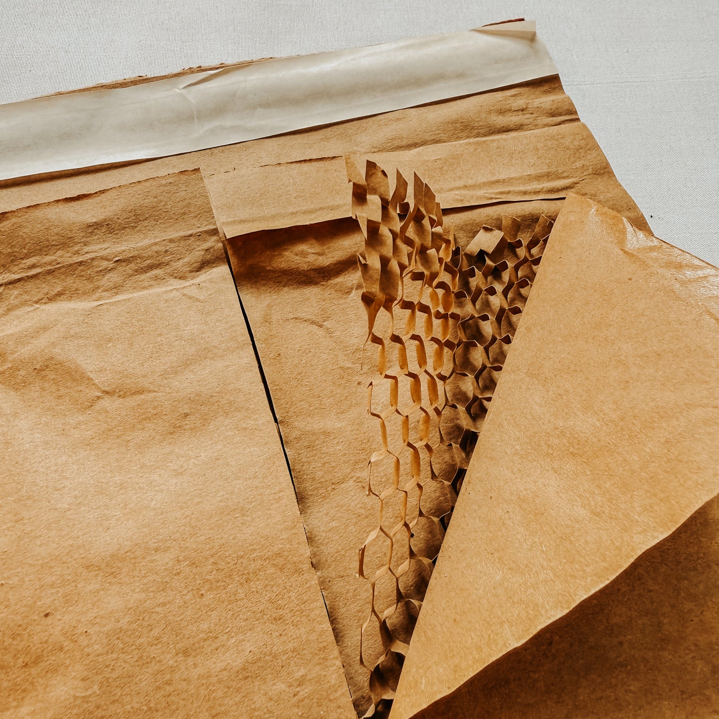 Jaivik Store EcoArmor shockproof paper mailer displayed flat, emphasizing its 6-layer protective structure