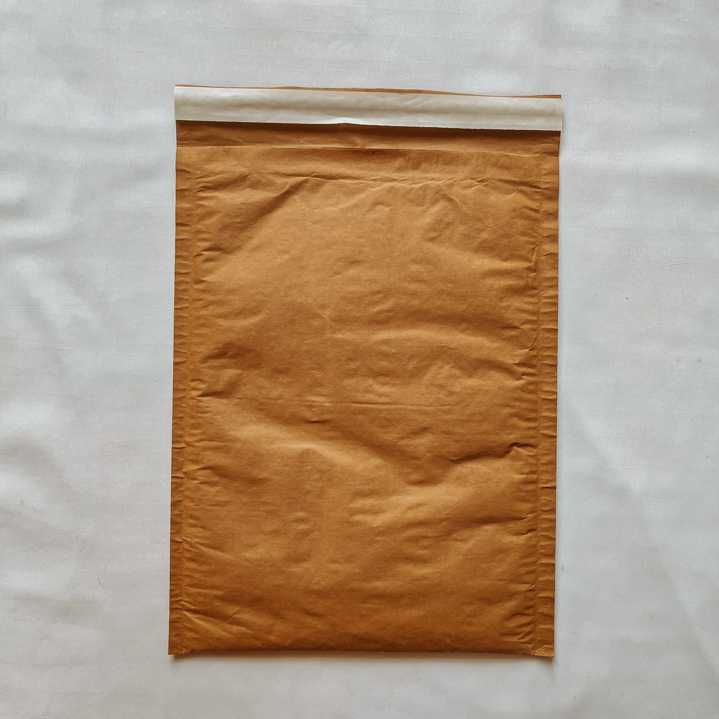 Back view of Jaivik Store EcoArmor shockproof paper mailer pack of 10, durable and eco-friendly