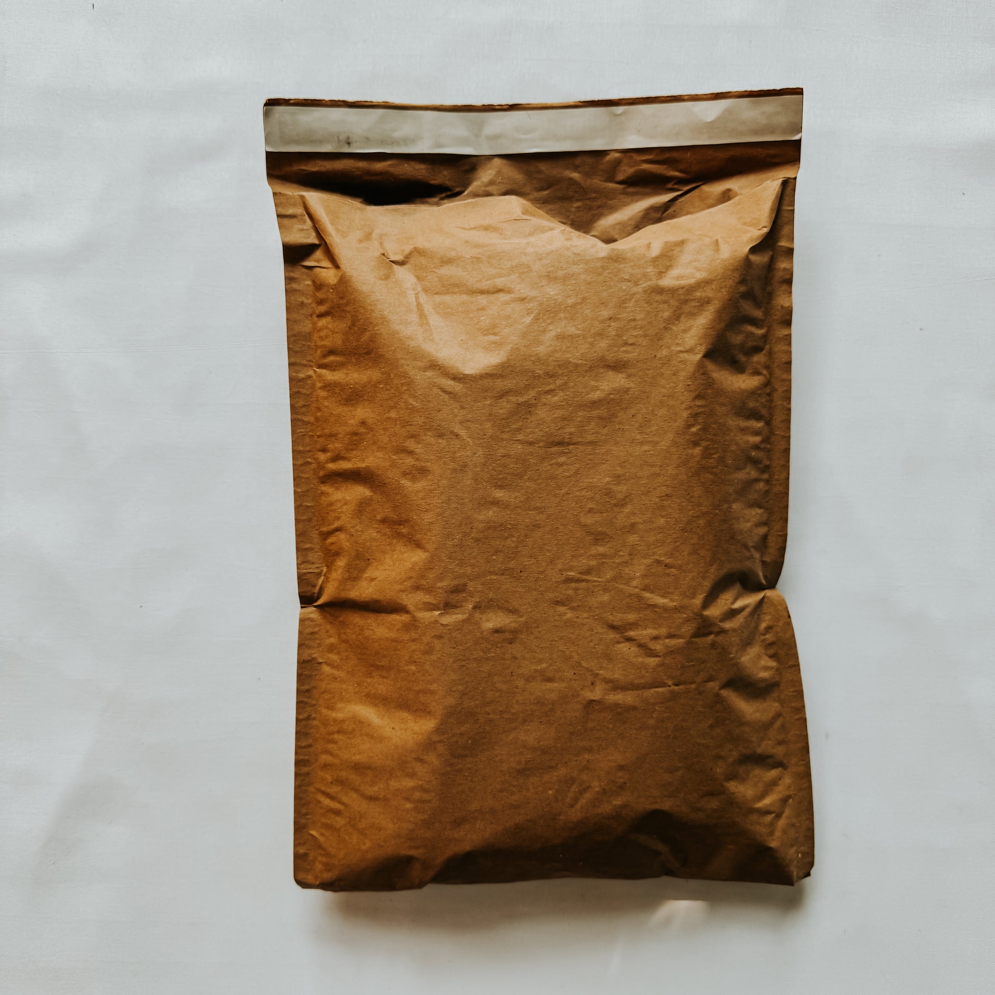 Jaivik Store EcoArmor shockproof paper mailer filled to capacity, demonstrating protective and sustainable packaging
